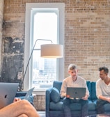 three men using MacBooks