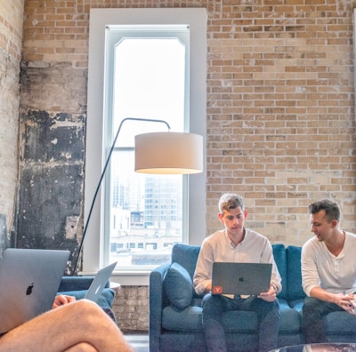 three men using MacBooks