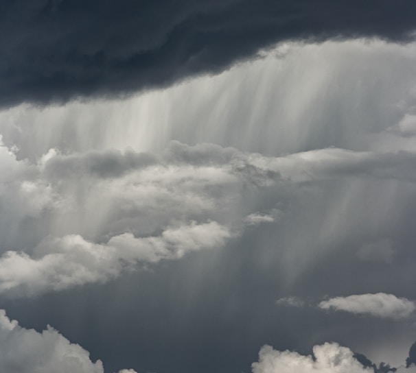 white clouds over mountain during daytime